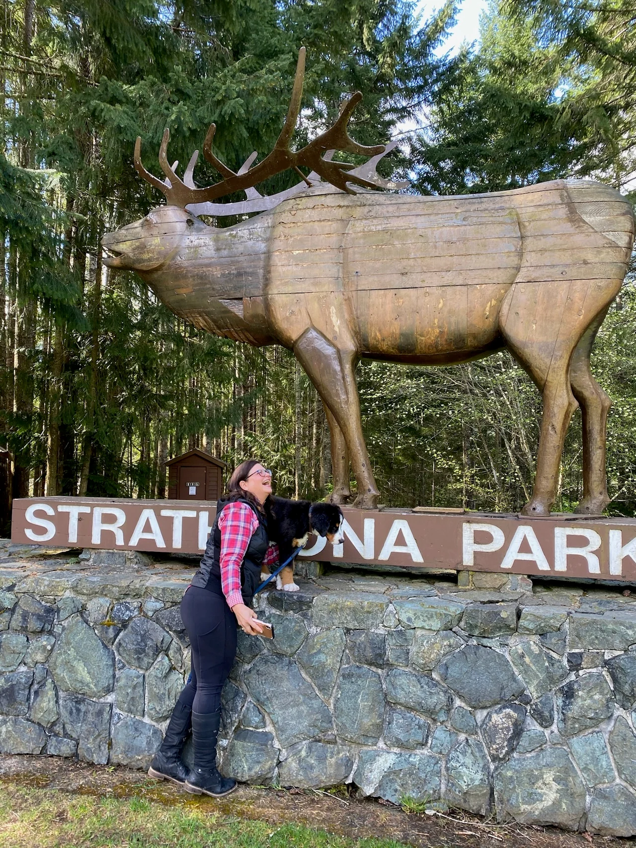 Me laughing beside the Strathcona Park sign, with Fraser in front of me